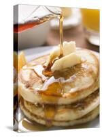 Pouring Maple Syrup over Pancakes with Dab of Butter-null-Stretched Canvas