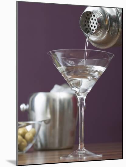 Pouring Martini Out of Cocktail Shaker into Glass-null-Mounted Photographic Print