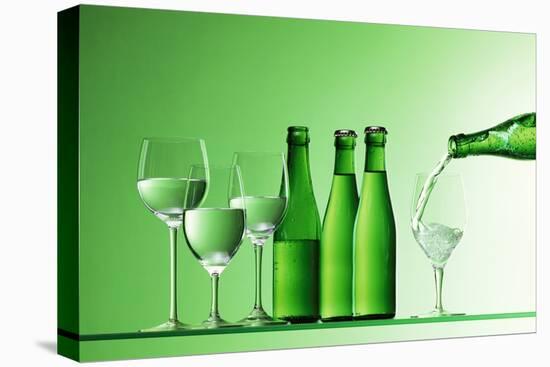 Pouring Mineral Water into Glass-Klaus Arras-Stretched Canvas