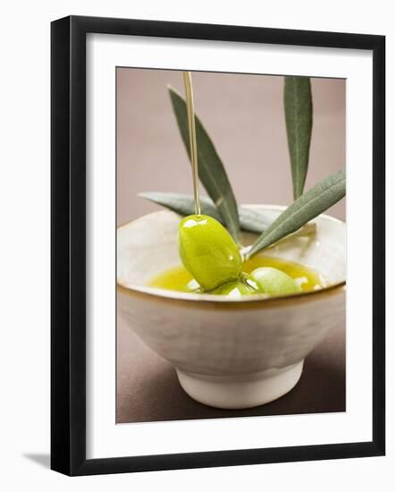 Pouring Olive Oil Over Olive Sprig with Green Olives-null-Framed Photographic Print