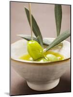 Pouring Olive Oil Over Olive Sprig with Green Olives-null-Mounted Photographic Print