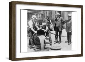 Pouring Out Illegal Alcohol into a Sewer-null-Framed Art Print