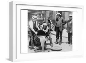 Pouring Out Illegal Alcohol into a Sewer-null-Framed Art Print