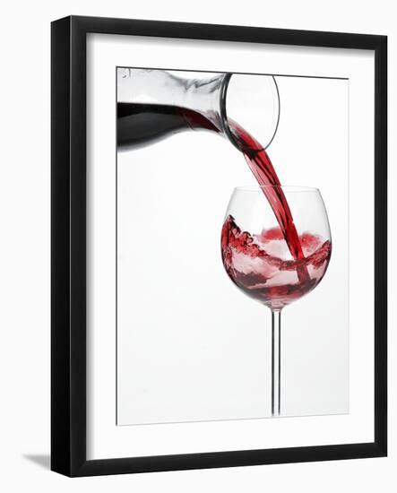 Pouring Red Wine into Glass from Carafe-Kröger & Gross-Framed Premium Photographic Print