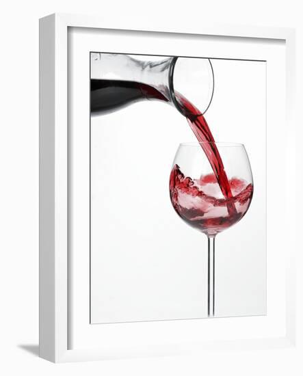 Pouring Red Wine into Glass from Carafe-Kröger & Gross-Framed Photographic Print