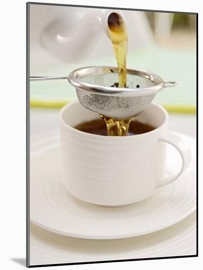 Pouring Tea Through a Tea Strainer-Winfried Heinze-Mounted Photographic Print