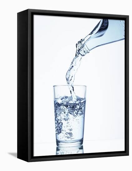 Pouring Water from a Bottle into a Glass-Petr Gross-Framed Stretched Canvas