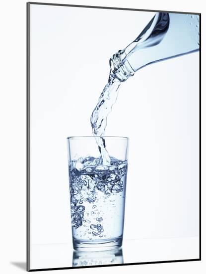 Pouring Water from a Bottle into a Glass-Petr Gross-Mounted Photographic Print