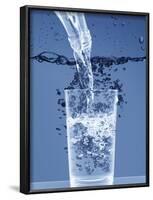 Pouring Water from a Bottle into a Glass-Petr Gross-Framed Photographic Print