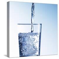Pouring Water into a Glass-Kai Schwabe-Stretched Canvas