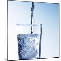 Pouring Water into a Glass-Kai Schwabe-Mounted Photographic Print