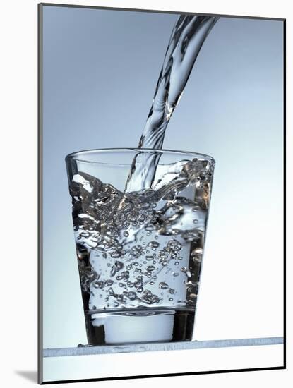 Pouring Water into a Glass-Bodo A^ Schieren-Mounted Photographic Print