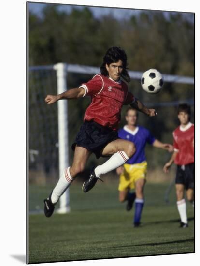 Powerful Leaping Soccer Player-null-Mounted Premium Photographic Print