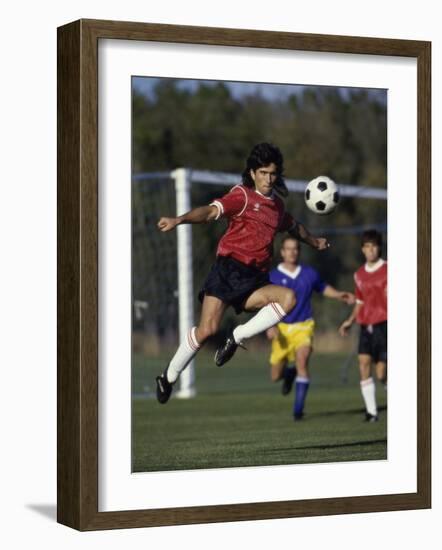 Powerful Leaping Soccer Player-null-Framed Photographic Print