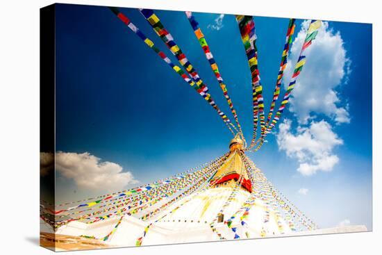 Prayer flags and Buddhist stupa at Bouddha (Boudhanath), UNESCO World Heritage Site, Kathmandu, Nep-Laura Grier-Stretched Canvas