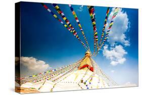 Prayer flags and Buddhist stupa at Bouddha (Boudhanath), UNESCO World Heritage Site, Kathmandu, Nep-Laura Grier-Stretched Canvas