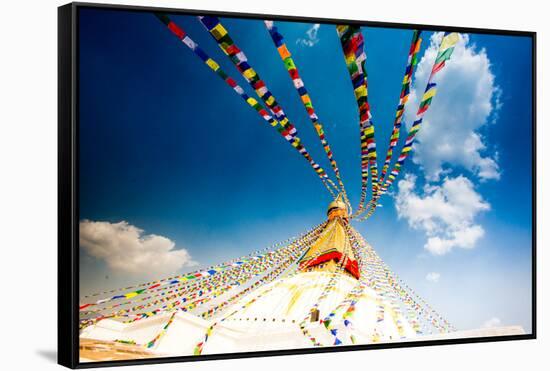 Prayer flags and Buddhist stupa at Bouddha (Boudhanath), UNESCO World Heritage Site, Kathmandu, Nep-Laura Grier-Framed Stretched Canvas