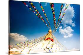 Prayer flags and Buddhist stupa at Bouddha (Boudhanath), UNESCO World Heritage Site, Kathmandu, Nep-Laura Grier-Stretched Canvas