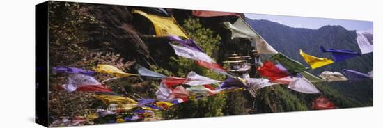 Prayer Flags in Front of a Monastery on a Mountain, Taktshang, Paro Valley, Bhutan-null-Stretched Canvas