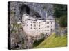 Predjama, Inner Carniola, Slovenia. Predjama Castle, built into the opening of a cave.-null-Stretched Canvas