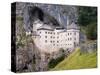 Predjama, Inner Carniola, Slovenia. Predjama Castle, built into the opening of a cave.-null-Stretched Canvas