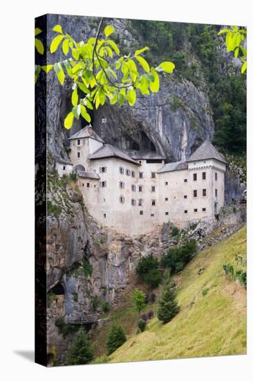 Predjama, Inner Carniola, Slovenia. Predjama Castle, built into the opening of a cave.-null-Stretched Canvas