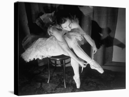 Premier Ballerina Semionova Tying Her Toe Shoe Before a Performance at the Great Theater-Margaret Bourke-White-Stretched Canvas