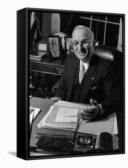 Pres. Harry S. Truman Seated at His Desk in the White House, Family Photographs on Table Behind Him-Gjon Mili-Framed Stretched Canvas