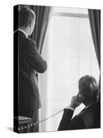 Pres. John F. Kennedy on Telephone While Brother, Attorney General Robert F. Kennedy Stands Nearby-Art Rickerby-Stretched Canvas