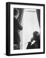 Pres. John F. Kennedy on Telephone While Brother, Attorney General Robert F. Kennedy Stands Nearby-Art Rickerby-Framed Premium Photographic Print