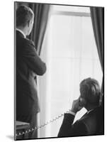 Pres. John F. Kennedy on Telephone While Brother, Attorney General Robert F. Kennedy Stands Nearby-Art Rickerby-Mounted Photographic Print