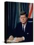 Pres. John F. Kennedy Sitting at His Desk, with Flag in Bkgrd-Alfred Eisenstaedt-Stretched Canvas