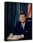 Pres. John F. Kennedy Sitting at His Desk, with Flag in Bkgrd-Alfred Eisenstaedt-Framed Stretched Canvas