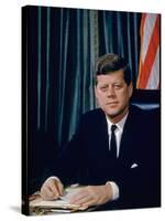 Pres. John F. Kennedy Sitting at His Desk, with Flag in Bkgrd-Alfred Eisenstaedt-Stretched Canvas