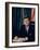 Pres. John F. Kennedy Sitting at His Desk, with Flag in Bkgrd-Alfred Eisenstaedt-Framed Premium Photographic Print