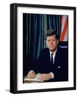 Pres. John F. Kennedy Sitting at His Desk, with Flag in Bkgrd-Alfred Eisenstaedt-Framed Premium Photographic Print