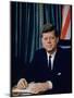 Pres. John F. Kennedy Sitting at His Desk, with Flag in Bkgrd-Alfred Eisenstaedt-Mounted Photographic Print