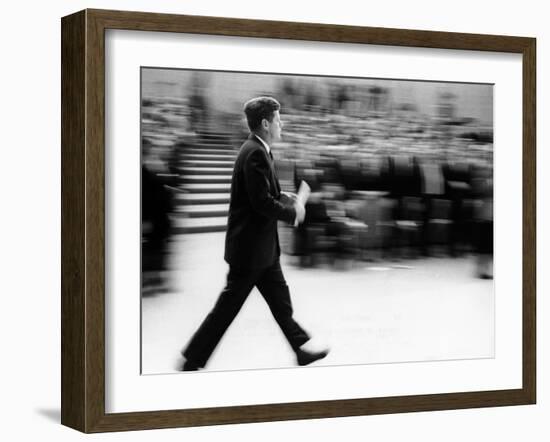 Pres John Kennedy Walking Fast after Press Conference in State Department Auditorium, Mar 11, 1963-null-Framed Photo