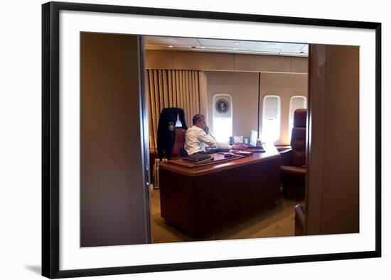 President Barack Obama Holds a Conference Call with Advisors from His Office Aboard Air Force One-null-Framed Photo