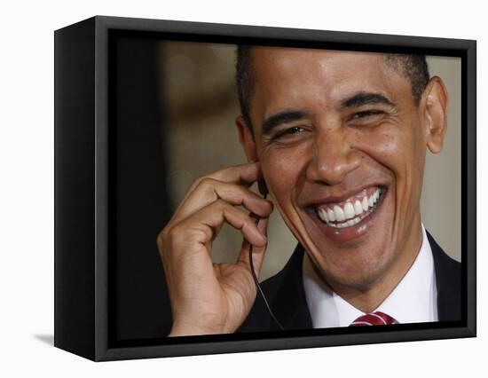 President Barack Obama Smiles as He Participates in a Joint News Conference in the White House-null-Framed Stretched Canvas