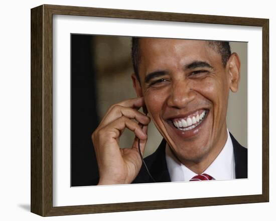 President Barack Obama Smiles as He Participates in a Joint News Conference in the White House-null-Framed Photographic Print