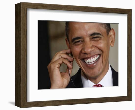 President Barack Obama Smiles as He Participates in a Joint News Conference in the White House-null-Framed Photographic Print