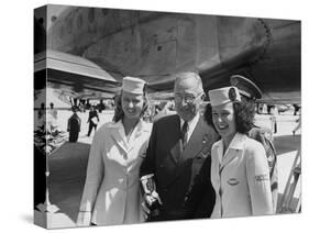 President Harry S. Truman Standing Near a Plane Flanked by Stewardesses-null-Stretched Canvas