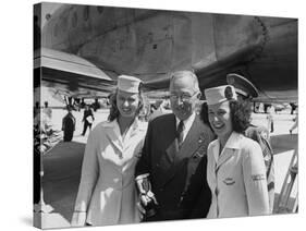 President Harry S. Truman Standing Near a Plane Flanked by Stewardesses-null-Stretched Canvas