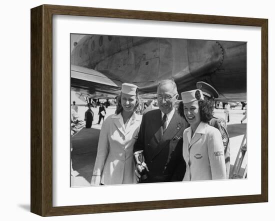 President Harry S. Truman Standing Near a Plane Flanked by Stewardesses-null-Framed Photographic Print