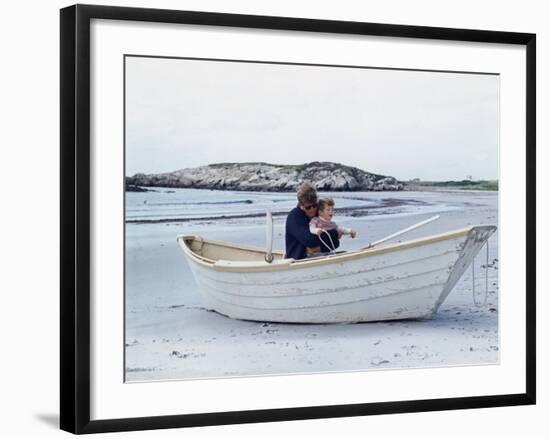 President John Kennedy and John Jr. Play in a Beached Rowboat at Newport, Rhode Island. 1962-null-Framed Photo