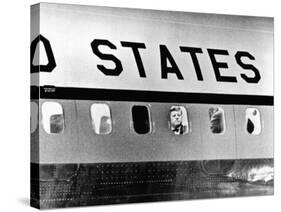 President John Kennedy Peers Out from Window of Air Force One-null-Stretched Canvas