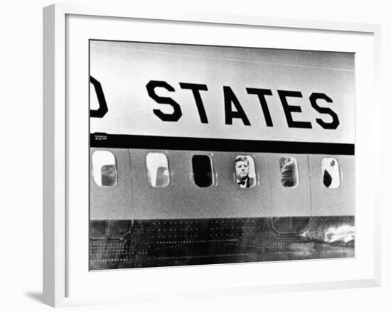 President John Kennedy Peers Out from Window of Air Force One-null-Framed Photo