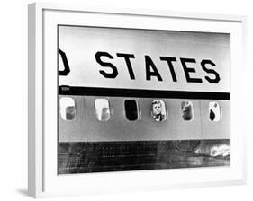 President John Kennedy Peers Out from Window of Air Force One-null-Framed Photo