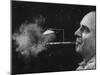 President of Zeus Corp., Robert Stern, Smoking from Self-Designed "Rainy Day" Cigarette Holder-Yale Joel-Mounted Photographic Print